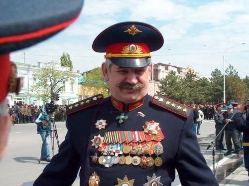 A real photo of a fake Cossack with laughable number of medals of chest .